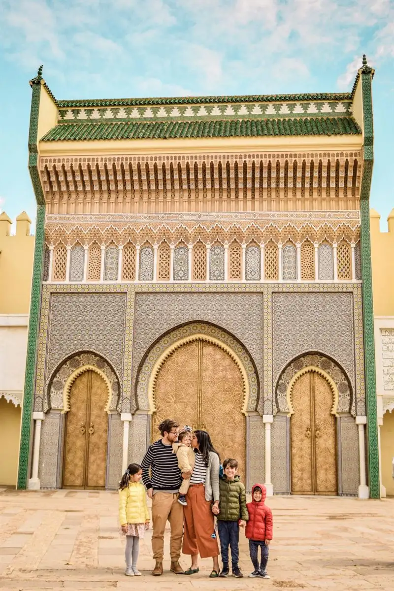 A family in front of the golden doors of the Royal Palace in Fes